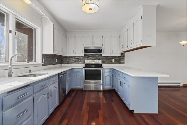 kitchen featuring sink, a baseboard radiator, white cabinets, and appliances with stainless steel finishes