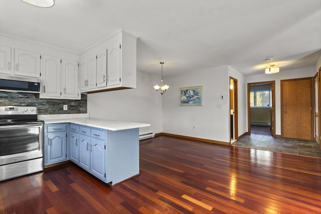 kitchen featuring appliances with stainless steel finishes, tasteful backsplash, white cabinets, decorative light fixtures, and kitchen peninsula