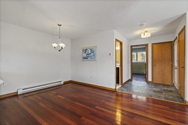 empty room featuring dark hardwood / wood-style floors, a notable chandelier, and baseboard heating