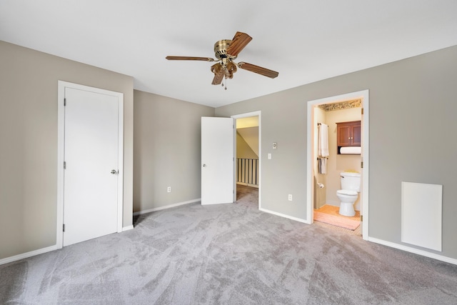 unfurnished bedroom with ensuite bath, light carpet, and ceiling fan