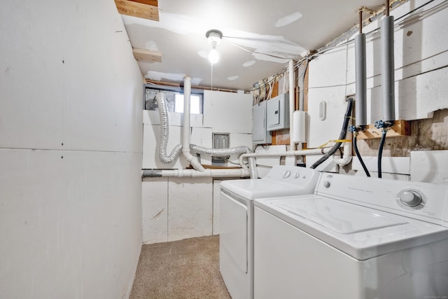 laundry room featuring washing machine and clothes dryer, electric panel, and light colored carpet