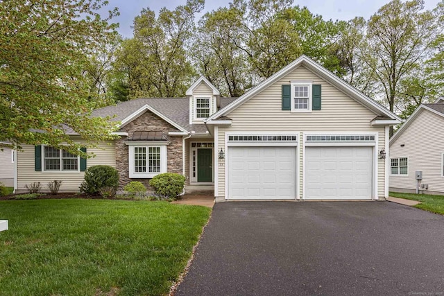view of front of property with stone siding, a garage, aphalt driveway, a shingled roof, and a front yard