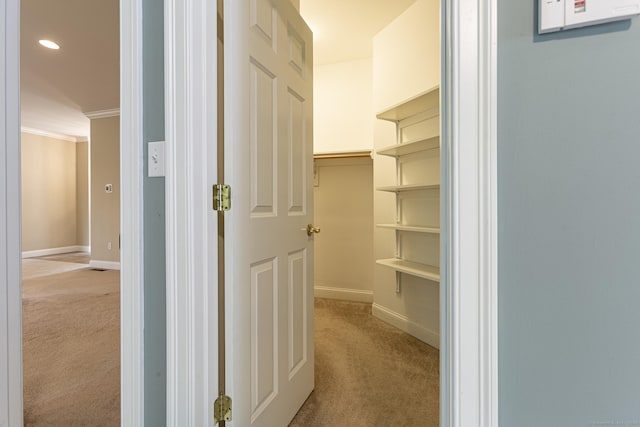 interior space featuring baseboards, light carpet, ornamental molding, and recessed lighting