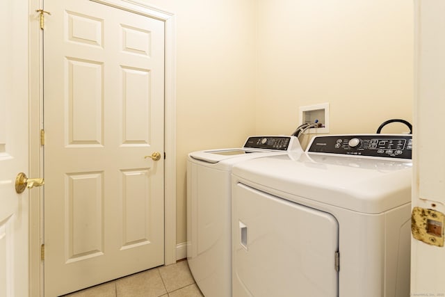 washroom with washer and clothes dryer, laundry area, and light tile patterned flooring