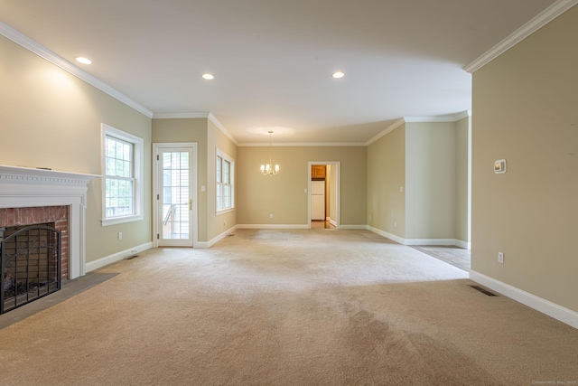 unfurnished living room with visible vents, a brick fireplace, a chandelier, crown molding, and light carpet