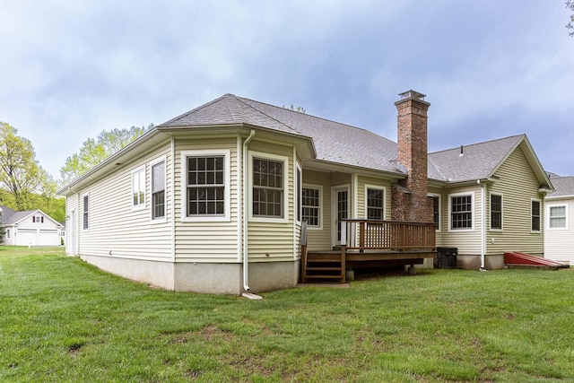 rear view of property featuring a yard, a deck, and a chimney