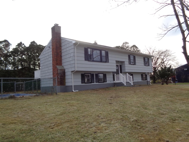 split foyer home with a front lawn