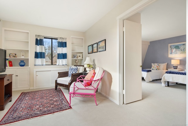 sitting room with light carpet and built in features