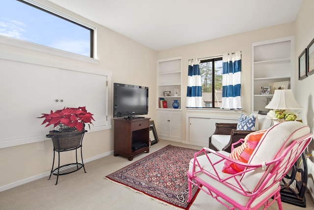 carpeted living room featuring built in shelves