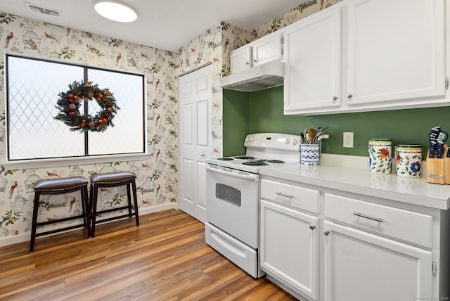 kitchen featuring electric stove, white cabinetry, and light hardwood / wood-style flooring