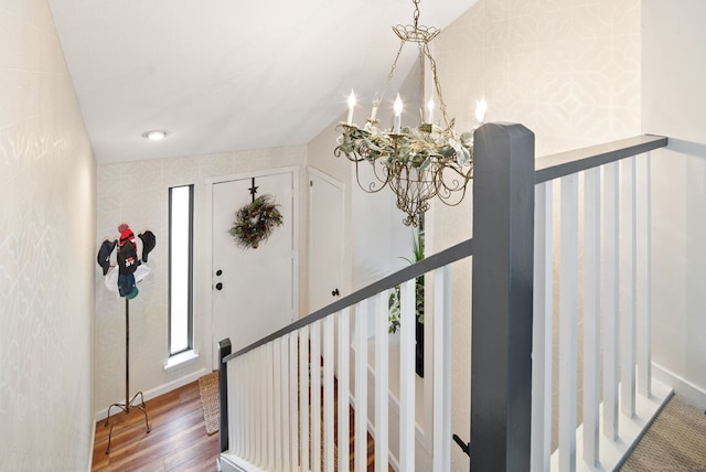 foyer featuring dark wood-type flooring and a notable chandelier