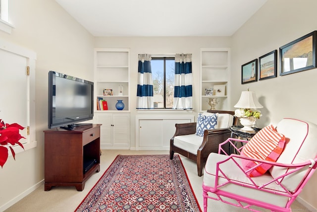 living area featuring light colored carpet and built in features