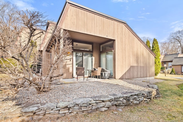 rear view of property featuring a patio area