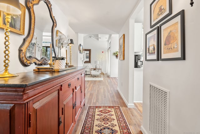 hall with light hardwood / wood-style flooring