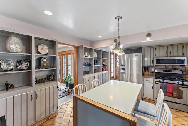 kitchen with decorative light fixtures, appliances with stainless steel finishes, and gray cabinets