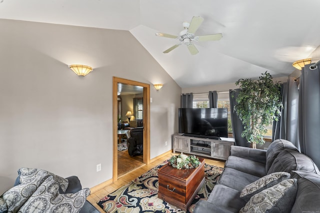 living room featuring ceiling fan, light hardwood / wood-style flooring, and vaulted ceiling