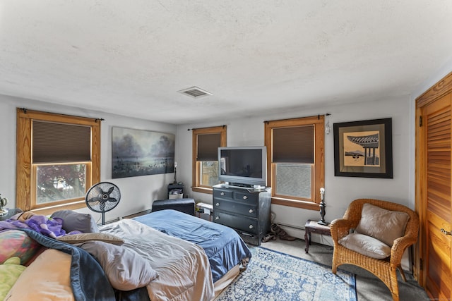 bedroom featuring baseboard heating and a textured ceiling