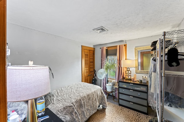 bedroom featuring a textured ceiling and a closet