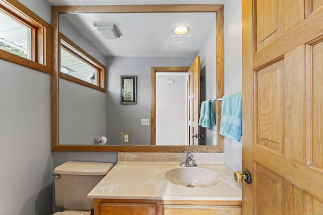 bathroom featuring vanity and toilet