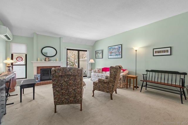 living room featuring a textured ceiling, light carpet, a fireplace, and a wall unit AC