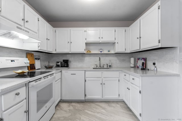 kitchen featuring sink, white appliances, white cabinets, and backsplash