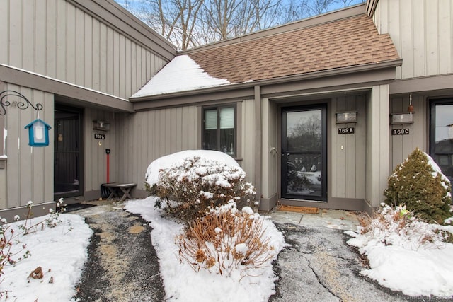 view of snow covered property entrance