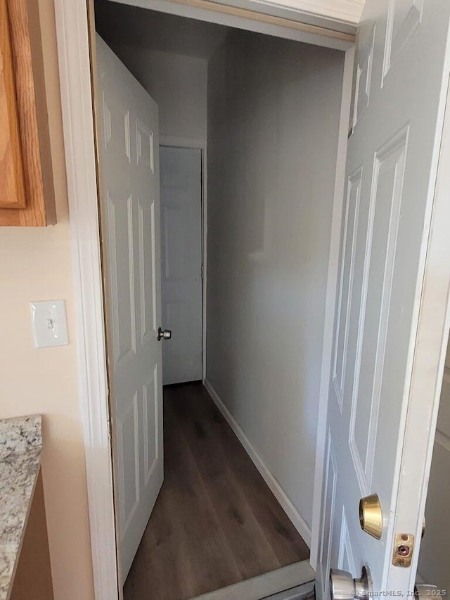 hallway with dark hardwood / wood-style floors