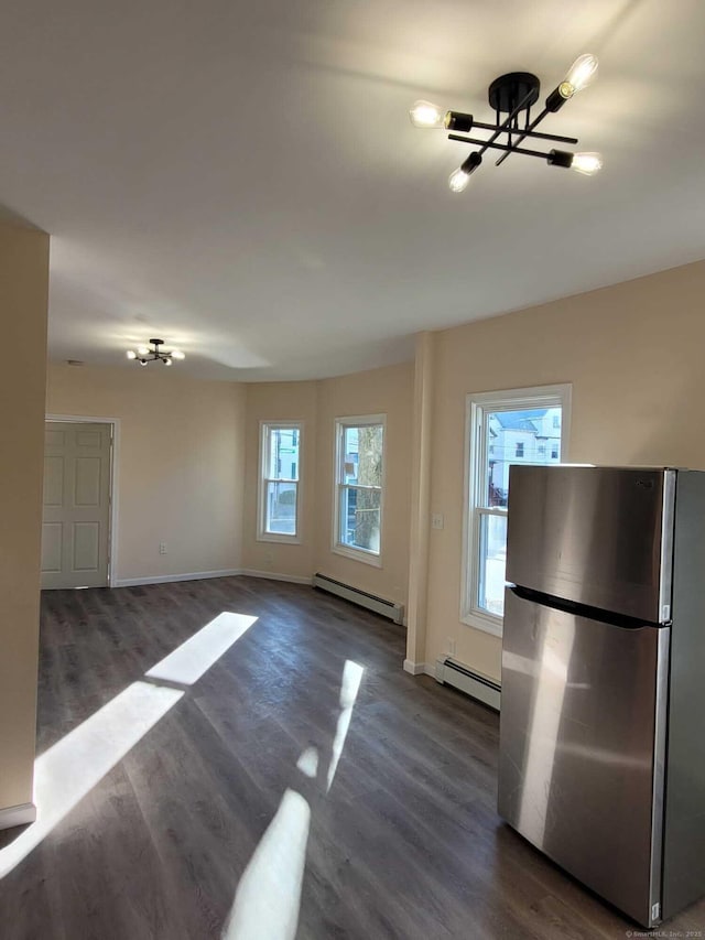 kitchen featuring dark hardwood / wood-style floors, stainless steel refrigerator, and baseboard heating