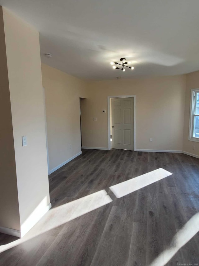 empty room with dark hardwood / wood-style flooring