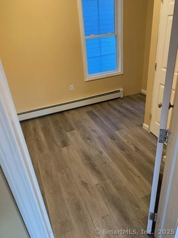 interior space with baseboard heating and dark hardwood / wood-style flooring