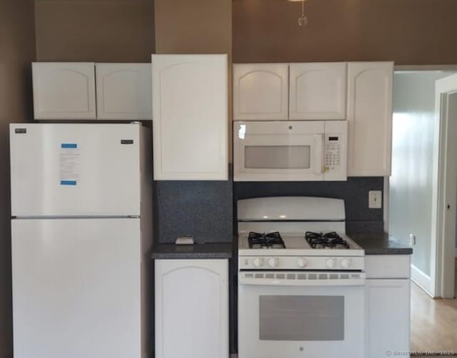 kitchen with tasteful backsplash, white appliances, light hardwood / wood-style floors, and white cabinets