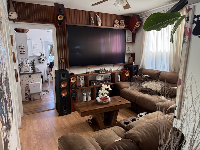 living room featuring ceiling fan and light wood-type flooring