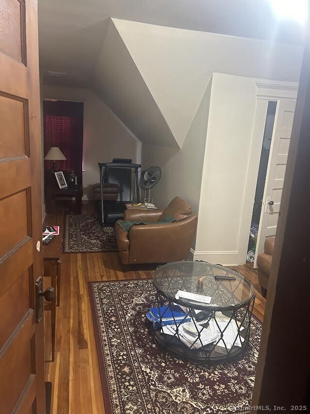 bonus room featuring lofted ceiling and hardwood / wood-style flooring