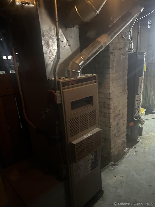 utility room featuring water heater