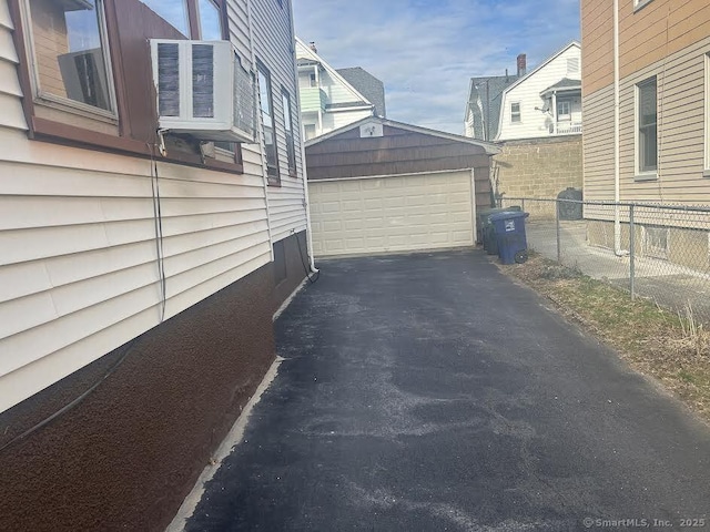 view of home's exterior featuring a garage and an outbuilding