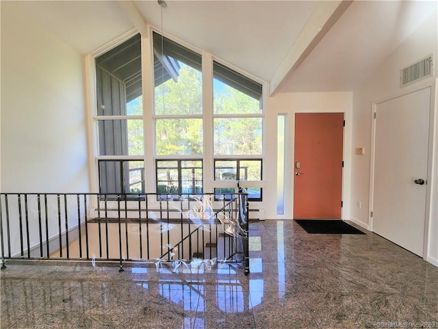 foyer entrance with high vaulted ceiling, baseboard heating, and beam ceiling