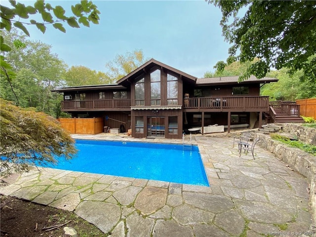 rear view of house featuring a patio area and a swimming pool side deck