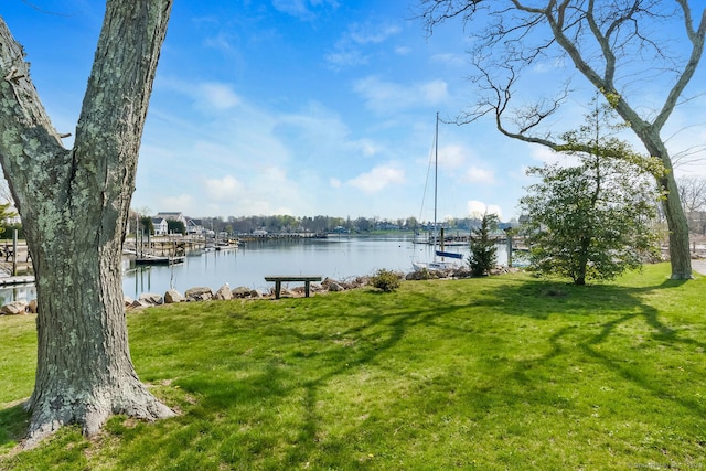 exterior space with a lawn and a water view