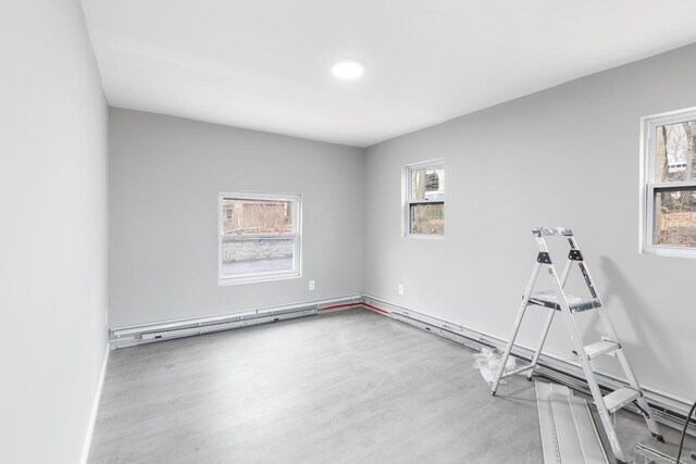 interior space featuring a baseboard radiator and light hardwood / wood-style floors