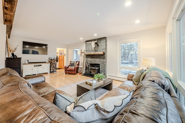 living room featuring light wood-type flooring and a baseboard heating unit