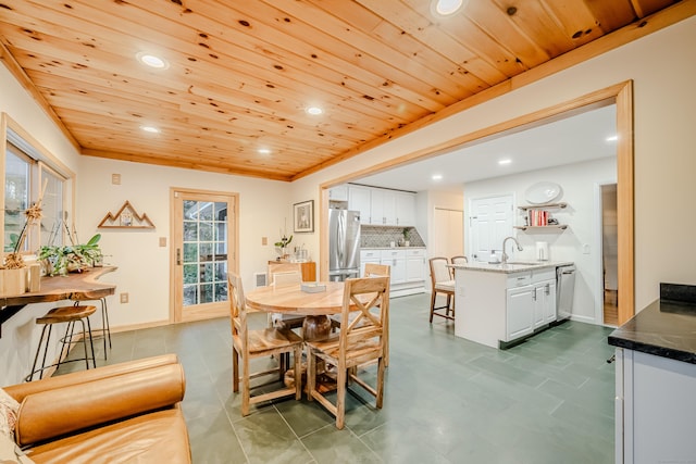 dining area featuring wood ceiling and sink