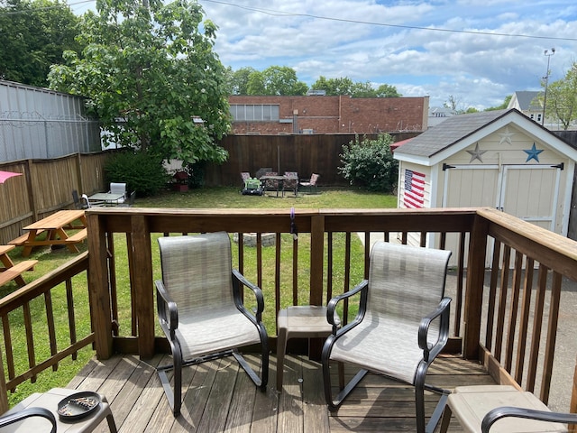 deck featuring a yard and a storage unit