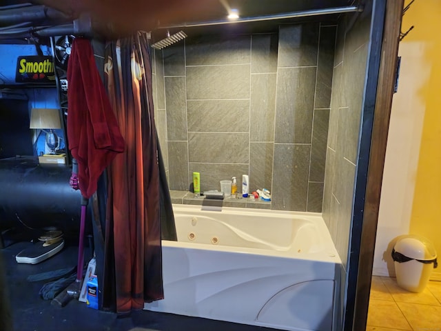 bathroom featuring tiled shower / bath combo and tile patterned flooring