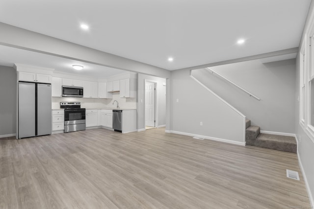 kitchen featuring white cabinetry, appliances with stainless steel finishes, and light wood-type flooring