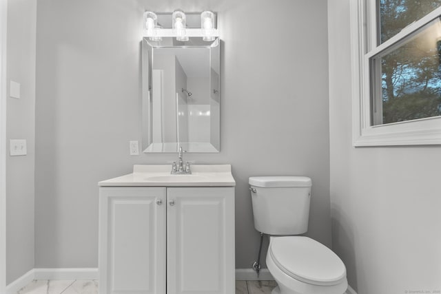 bathroom featuring toilet and vanity