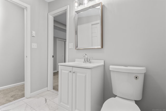 bathroom featuring toilet and vanity