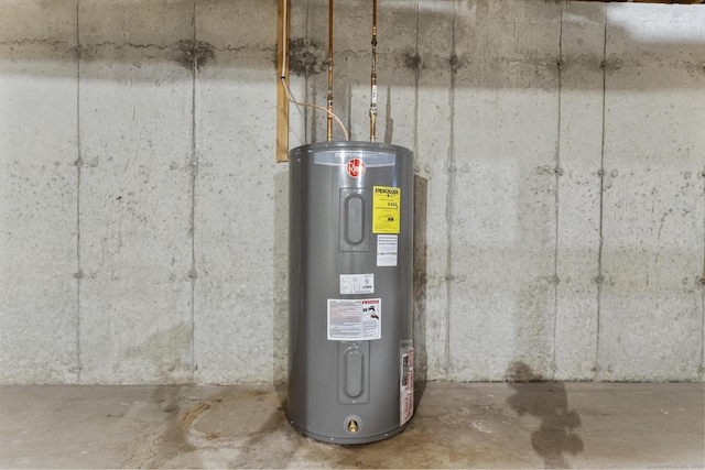 utility room featuring water heater