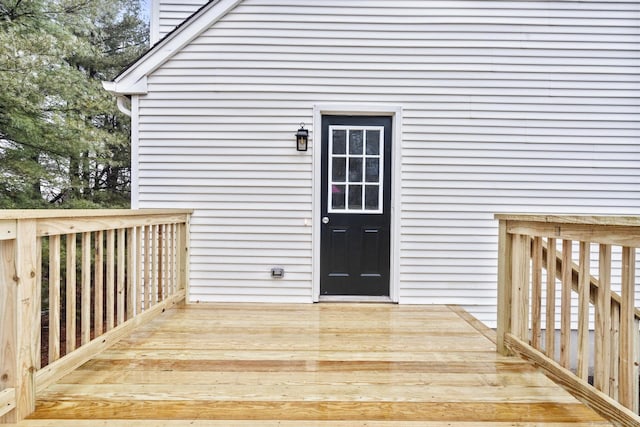 view of exterior entry with a wooden deck