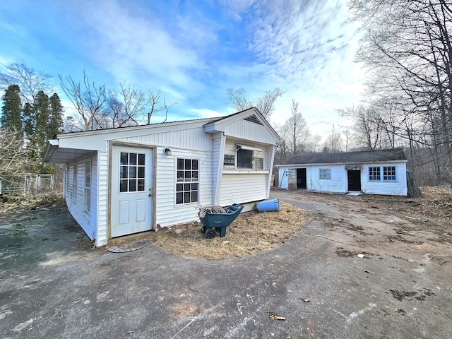 back of property with an outdoor structure