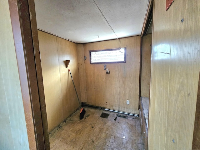 laundry area with wooden walls